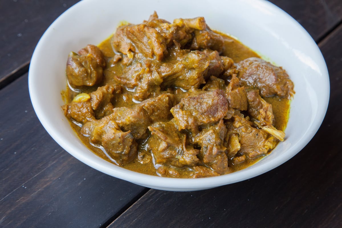 Plate of curried goat with rice